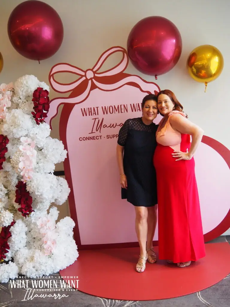 Karen and Tash in front of photo wall